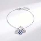 Silver bracelet with charms on a light gray background