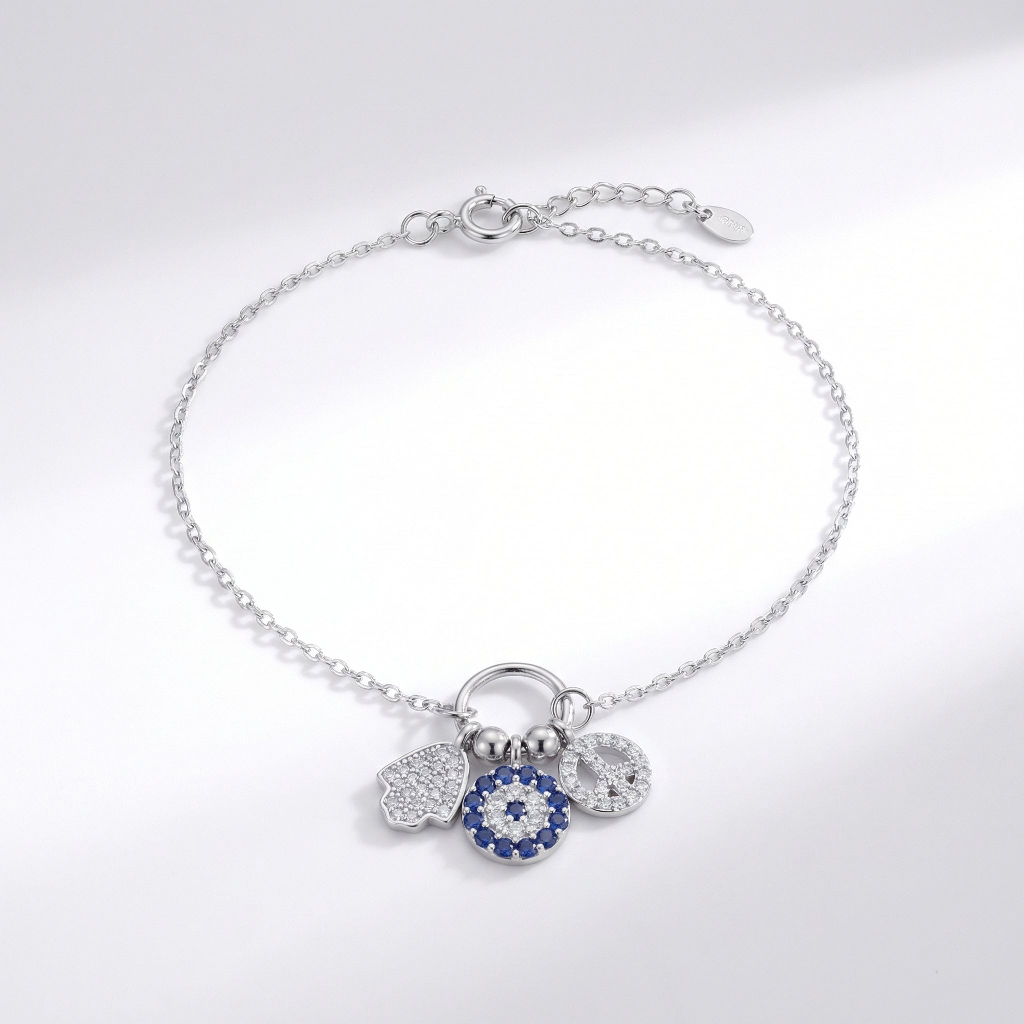 Silver bracelet with charms on a light gray background